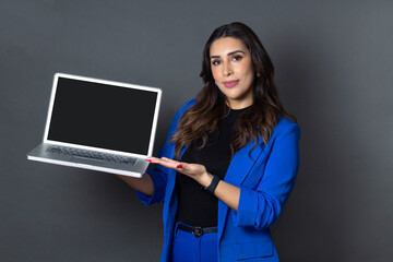 young hispanic business woman holding and showing laptop screen