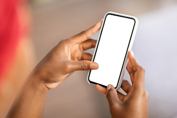 Unrecognizable black woman touching smartphone blank screen, cropped