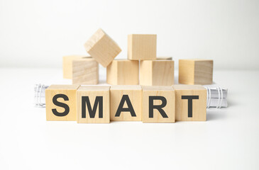 wooden cube block with smart business word on table background.