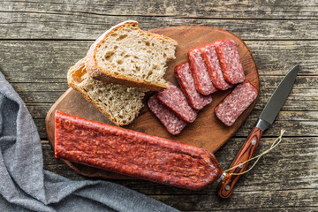 Smoked .sausage. Sliced salami on cutting board. Top view.
