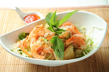 Yuzu Shrimp Salad with chilli sauce served in dish isolated on table green food