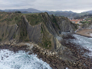 View on steeply-tilted layers of flysch geological formation on Atlantic coast at Zumaia, Basque...