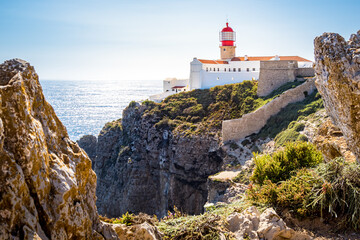 Fototapeta na wymiar Saint Vincent lighthouse, perched on top of the Cape Saint Vincent, provides a spectacular view of the Atlantic Ocean, making it a must-see tourist attraction in the Algarve region of Portugal.