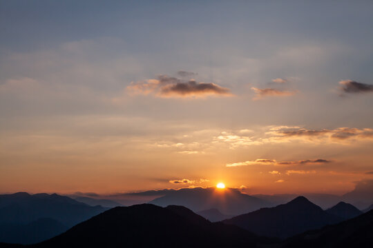sunset in the mountains with golden sky, clouds golden hour, sun, sun rays © VICTOR
