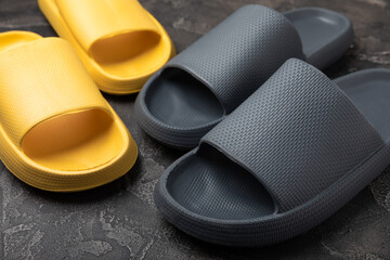 Home slippers on a black marble background. Indoor shoes. Flatley. Home cozy slippers for comfort. Close-up. Place for text. Copy space.