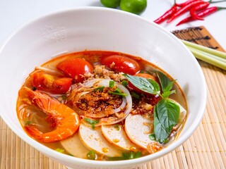 Hor Fun Soup with Fresh Tomato and Beef Brisket served in bowl isolated on table top view of Soup powder