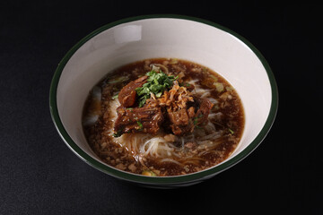 Braised pork noodles Thai street food isolated in black background - 589310508