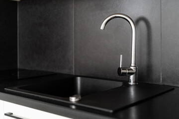 silver water tap and sink at modern apartment