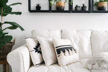 decorative pillows on white sofa in lounge room with bohemian style - obrazy, fototapety, plakaty