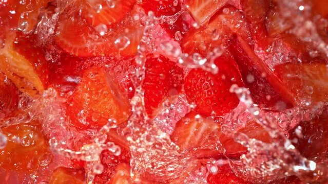 Super Slow Motion Shot of Fresh Strawberries Falling into Lemonade Whirl at 1000 fps.