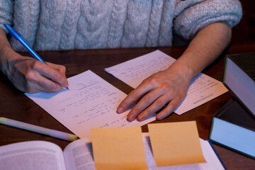 Student women writing her notes while studying