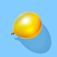Golden balloon on blue pastel background