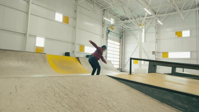 Young skater performing trick, skateboarder training in skatepark, making tricks, slides and flips, jump over the gap, professional extreme sport athlete ride on skateboard. 