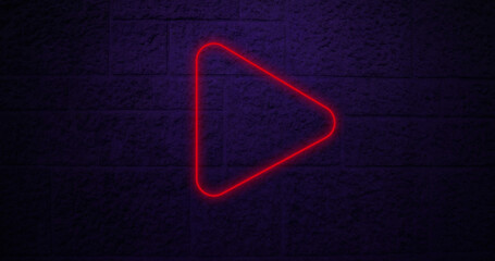 Image of red neon arrow icon on brick background