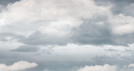 General view of dark and white multiple clouds over gray sky