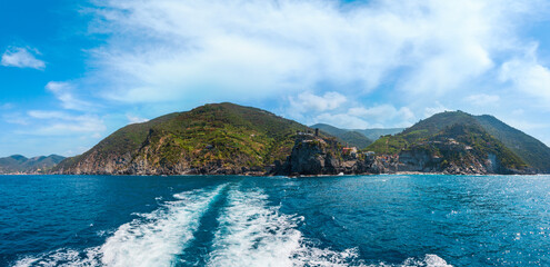 Beautiful summer Vernazza view from excursion ship. One of five famous villages of Cinque Terre National Park in Liguria, Italy, suspended between Ligurian sea and land on sheer cliffs.