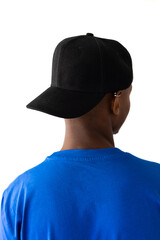 African american man wearing blue t-shirt and black cap with copy space on white background
