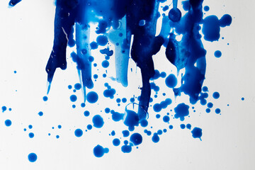 Close up of blue paint shapes on white background with copy space