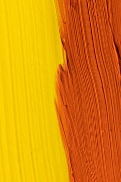 Close up of yellow and orange paint stripes with copy space