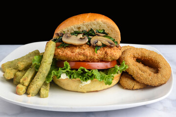 chicken sandwich top with suateed spinach and mushrooms