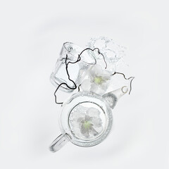 Transparent tea pot with white flowers