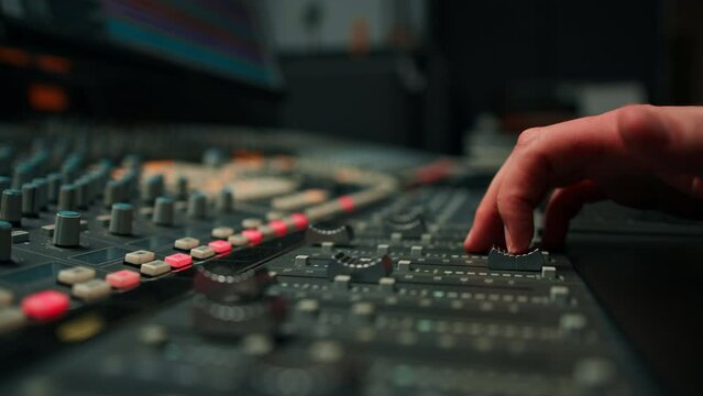 Close-up of mixer console hand adjusting faders A sound engineer works in the studio Professional recording studio 