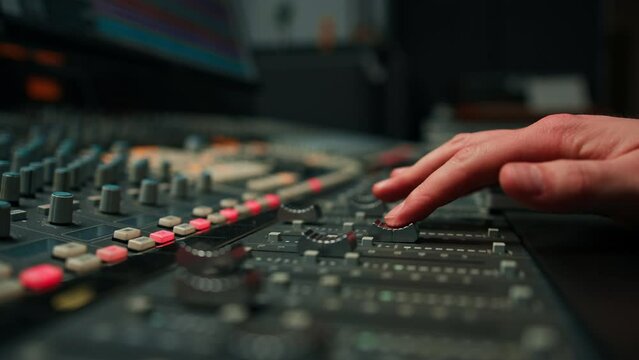 Close-up of mixer console hand adjusting faders A sound engineer works in the studio Professional recording studio 