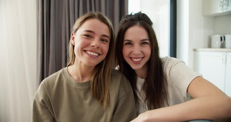 Portrait of happy attractive girls friends siblings embracing, smiling, looking at camera - Powered by Adobe