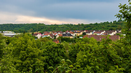 Fototapeta na wymiar Idyllic Summer View of Neudenau with Small Houses Surrounded by Greenery