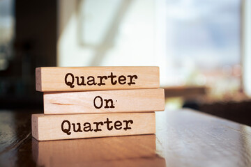 Wooden blocks with words 'Quarter On Quarter'.