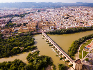 Naklejka premium Aerial view of cityscape of Cordoba with Roman Bridge over the Guadalquivir and the Mosque-Cathedral of Cordoba