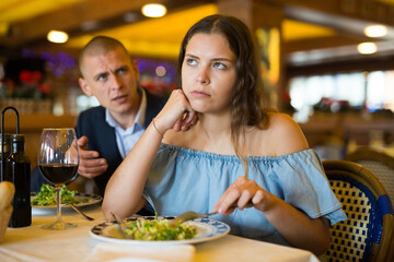 Portrait of couple having problems in relations, arguing in restaurant