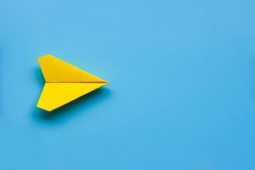 Top view of single yellow paper airplane with customizable space for text.
