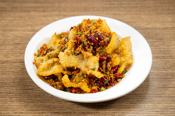 red chilli fried fish fillet served in dish isolated on mat top view on wooden table Hong Kong food