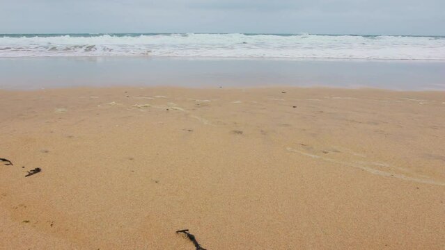 Perran Sands UK waves lapping against the beach