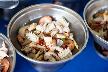 With its spicy and tangy flavors, Tom Yum is the perfect dinner choice, and I've assembled all the necessary seafood ingredients in the pot to make it.