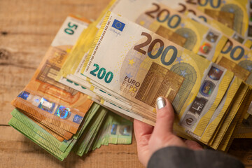 200 euro banknotes. Recalculation of money. Hands recalculate banknotes.Expenses and incomes in...