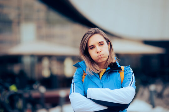 Stressed Woman with Arms Crossed Thinking What to Do . Unhappy millennial girl waiting outside being stood up
