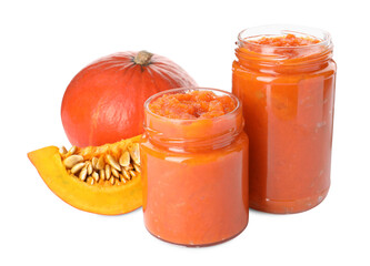 Jars of pumpkin jam and fresh pumpkin on white background