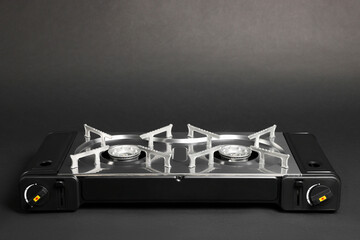 Portable gas stove on dark grey background, space for text. Military equipment