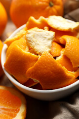 Orange peels preparing for drying and fresh fruits on table, closeup