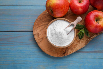 Sweet fructose powder, mint leaves and apples on light blue wooden table, top view. Space for text