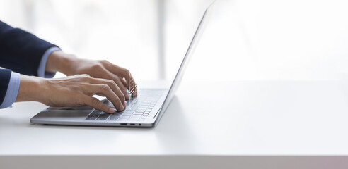 Businessman working on a laptop computer to document management online documentation database digital file storage system software records keeping database technology file access doc sharing.	