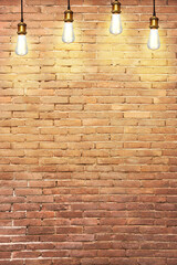 Many pendant lamps against old brick wall