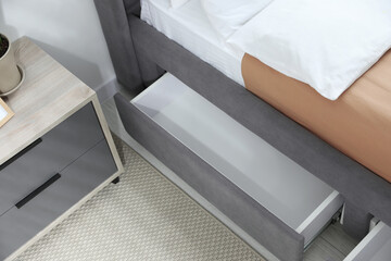 Storage drawer for bedding under modern bed in room
