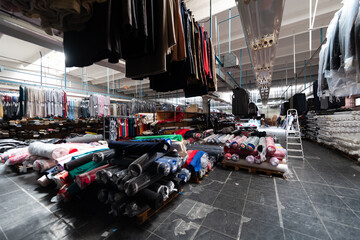 Obraz premium Interior of an industrial warehouse with fabric rolls samples. Small business textile colorful warehouse.