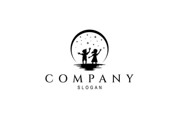 silhouette logo of boy and girl playing under the stars at night decorated with full moon