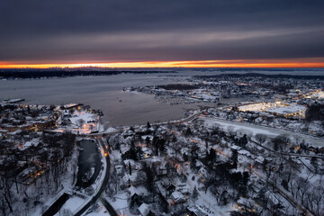 Sunset on Port Washington, Long Island covered in snow with NYC skyline in the distance 