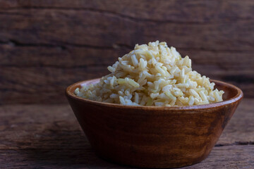 Organic Brown Rice in the bowl on the wooden table
