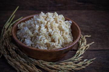 Organic Brown Rice in the bowl on the wooden table